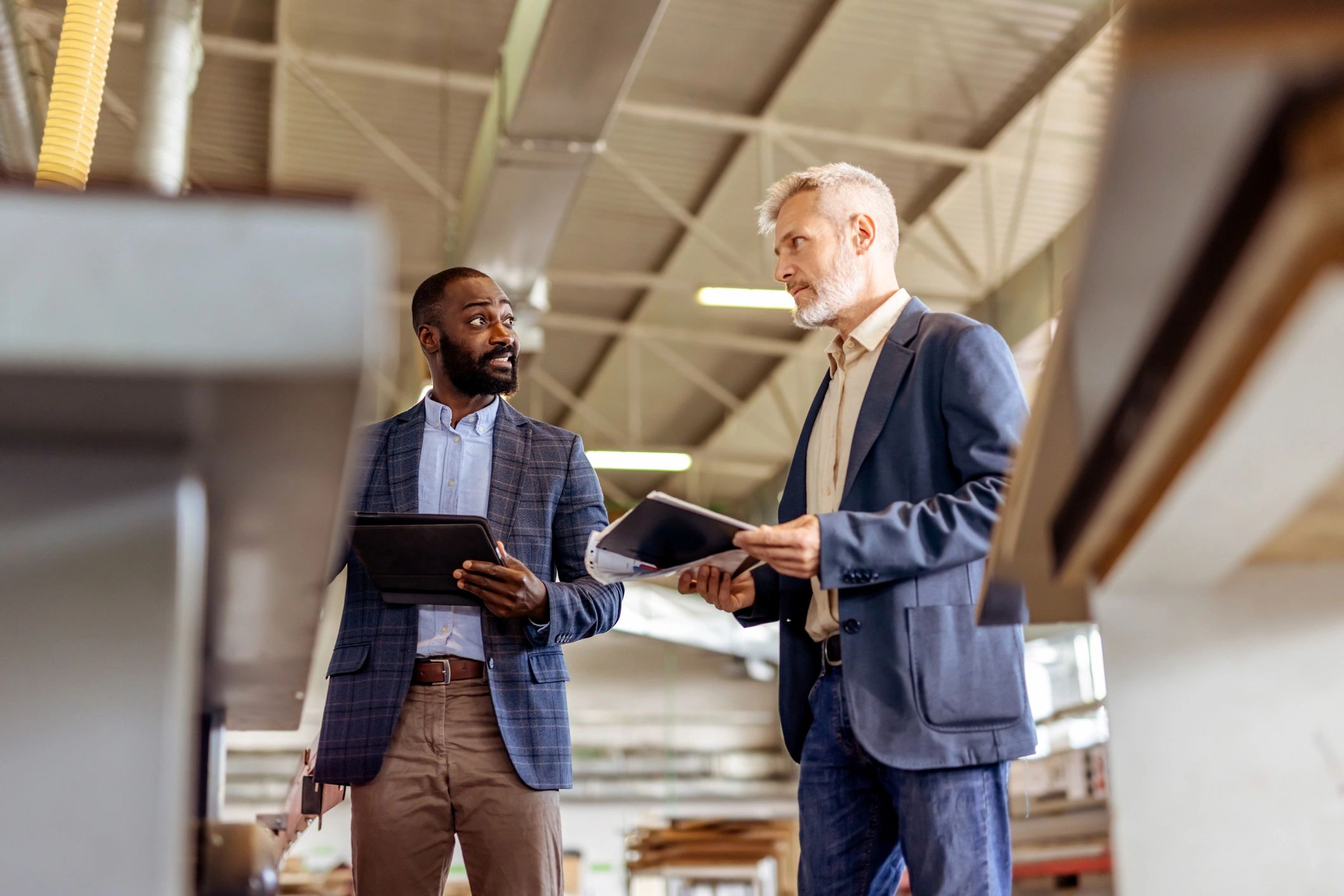 Professionals discussing hiring needs in an industrial workspace